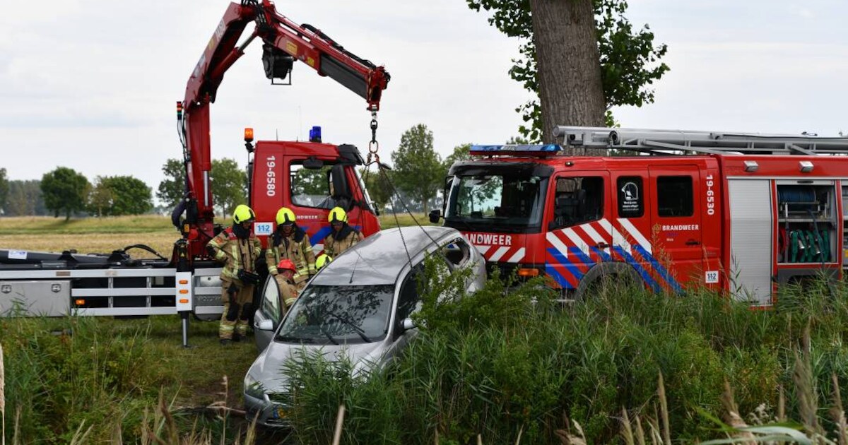 Auto op z'n kant in het water bij Kanaalweg in Oostburg | Sluis