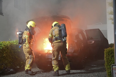 Elektrische auto vliegt in brand in Breda, brandweer blust vuur met grintkorrels
