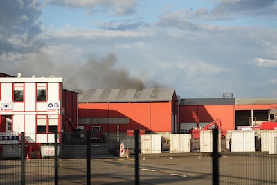 Brand in loods in Dongen: zwarte rookwolken boven gebouw